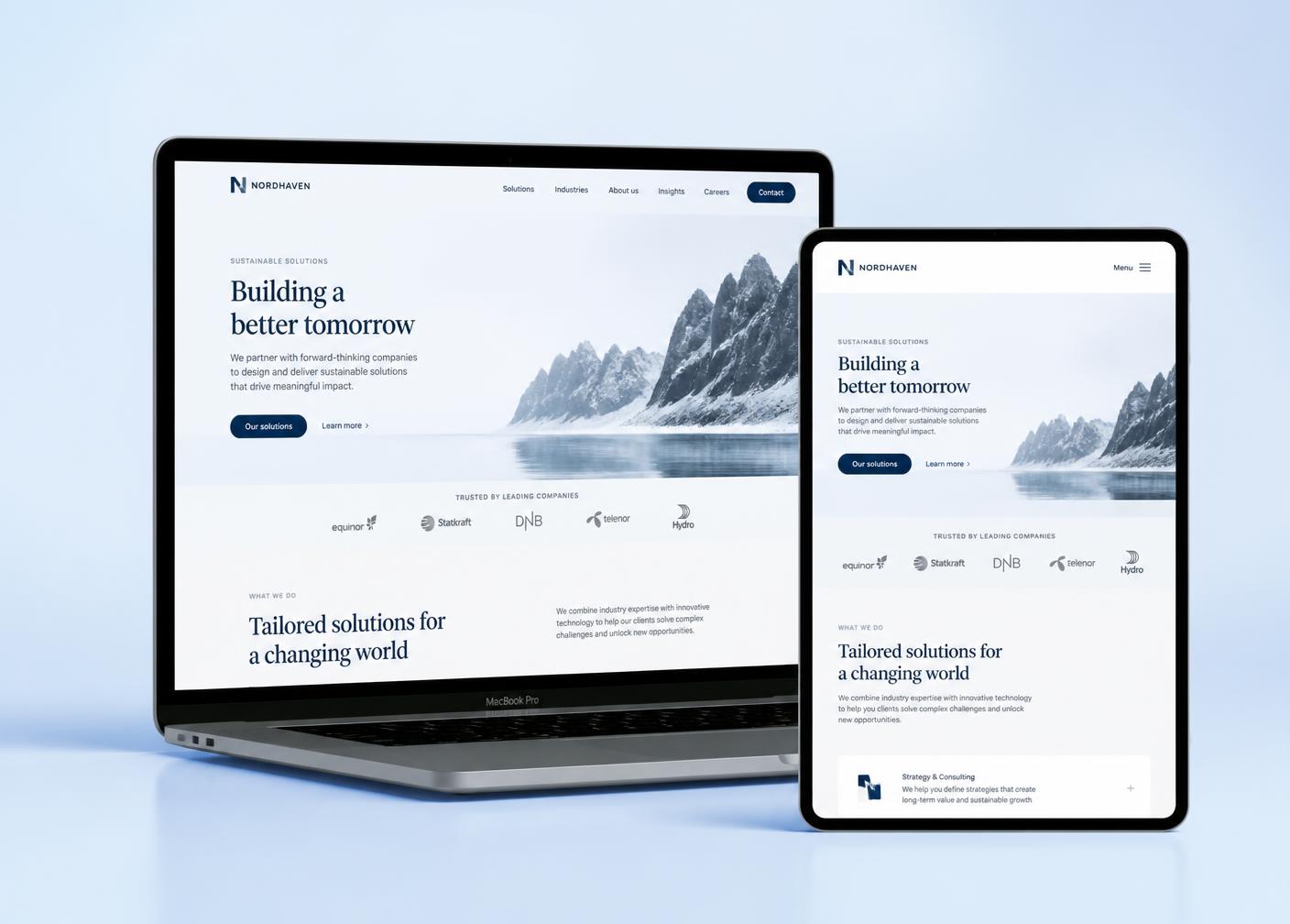 Corporate website design shown on a MacBook and iPad against a soft blue gradient
